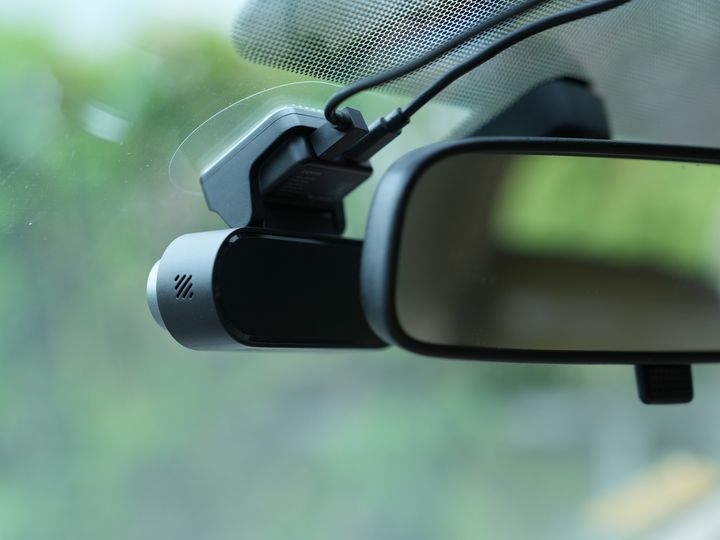 DDPAI N5 Dual dash cam securely mounted on a car's windshield next to the rearview mirror.