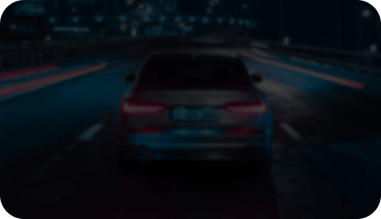 Darkened night-time footage of a car on a road, showing standard visibility before NightVIS 2.0 enhancement by DDPAI MINI2X dashcam.